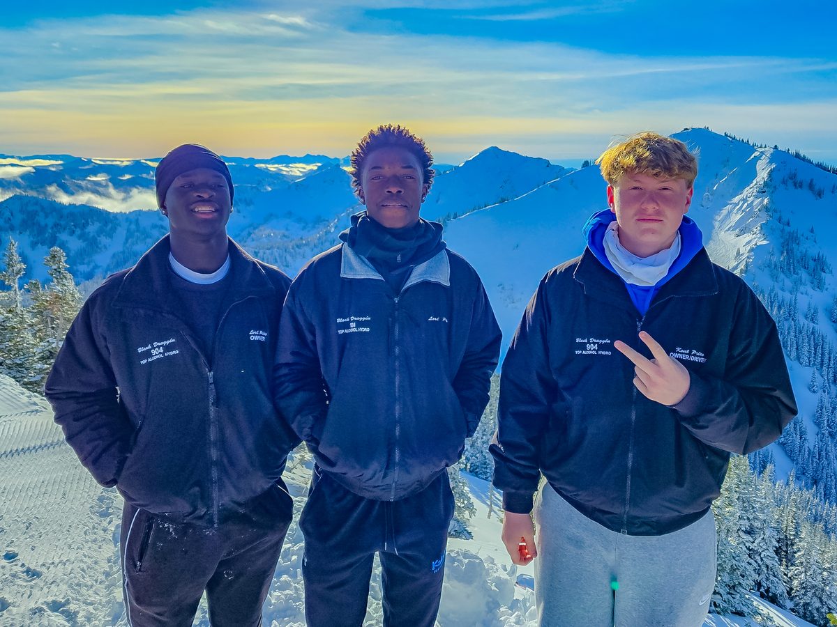 Asher Price with friends on a snowy mountain
